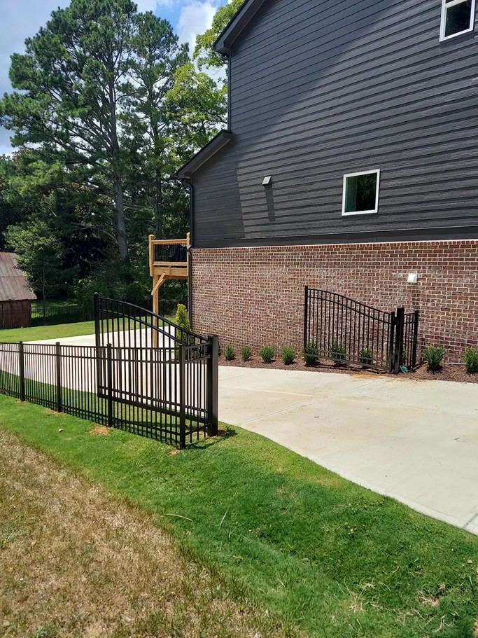 Arched black aluminum driveway gate