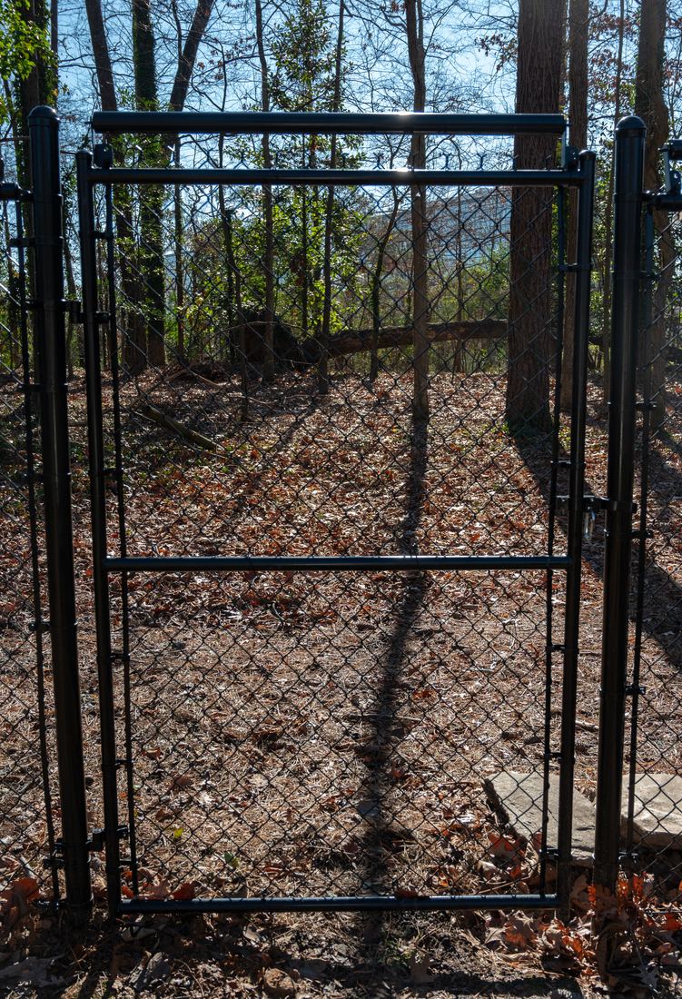 Black chain link gate with coyote rollers