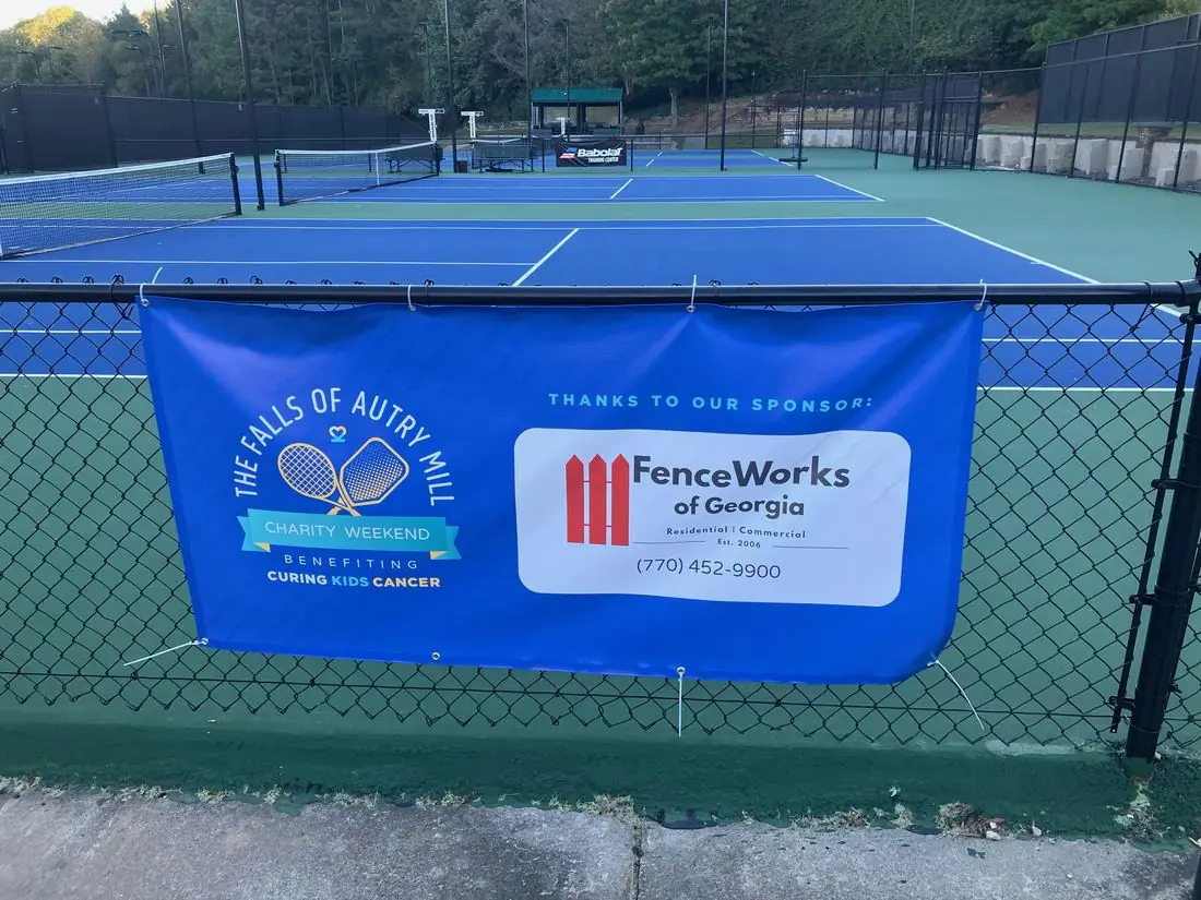 Black chain-link fencing around tennis courts at a metro-Atlanta athletic club
