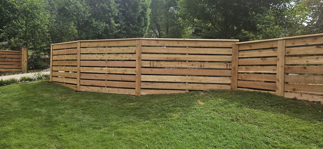 Cedar horizontal wood fence, stair-stepped with a beveled cap