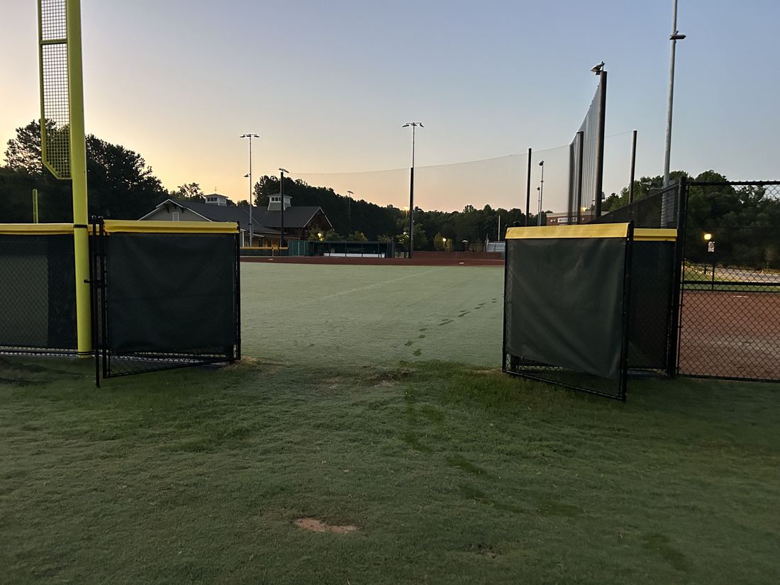 Chain link athletic fence with gate at a baseball field