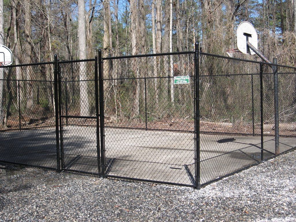 Chain link sports enclosure around a basketball court