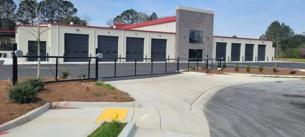 Black vinyl cantilever gate at a commercial property, installed by FenceWorks of Georgia