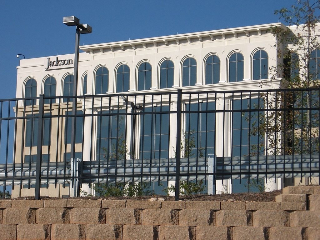 Black ornamental aluminum security fence on a wall outside a commercial building