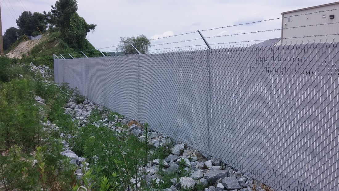 Commercial galvanized chain link with barbed wire and privacy slats