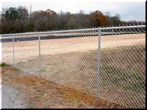 Galvanized chain link fence around a residential yard