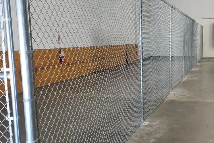 Galvanized chain-link warehouse partition with plated posts, installed by FenceWorks of Georgia