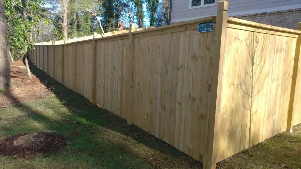 Cap-top pine wood privacy fence installed by FenceWorks of Georgia
