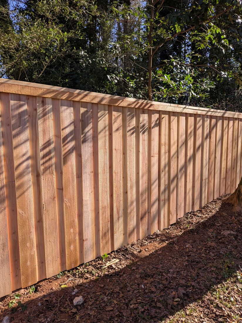 Board-on-board capped wood privacy fence built by FenceWorks of Georgia