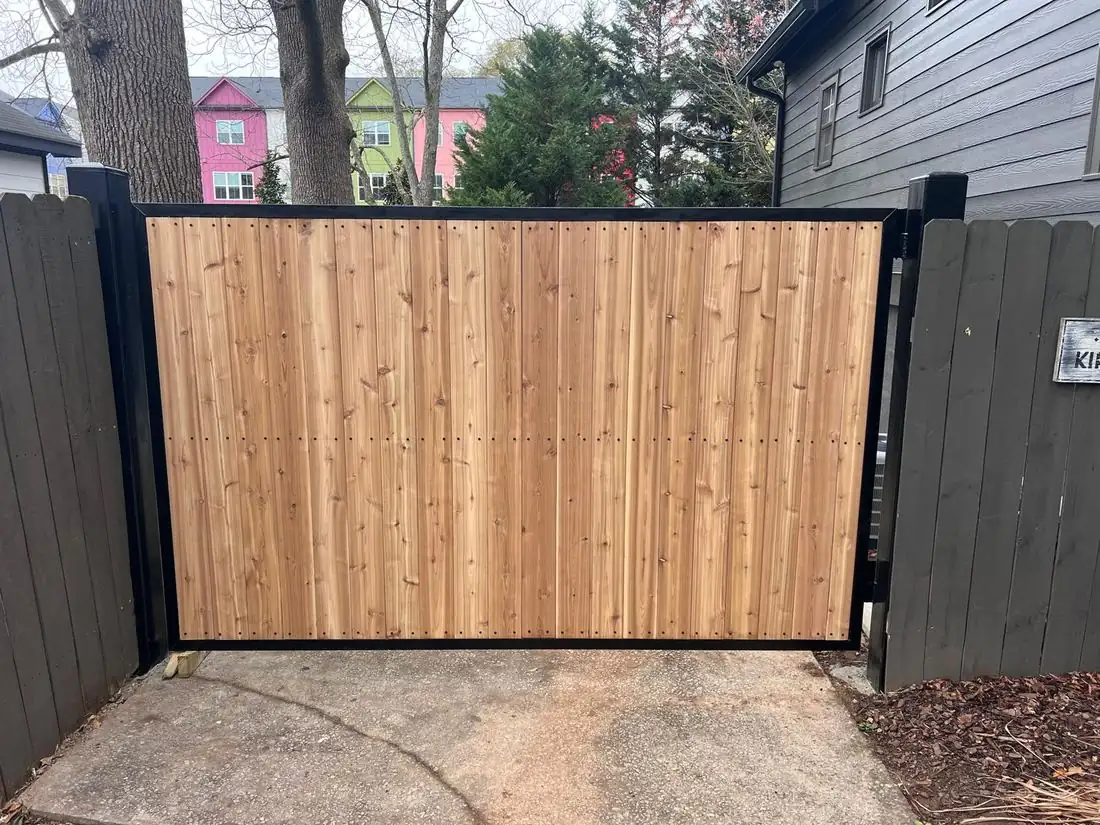 Custom cedar driveway gate built on a steel box frame by FenceWorks of Georgia