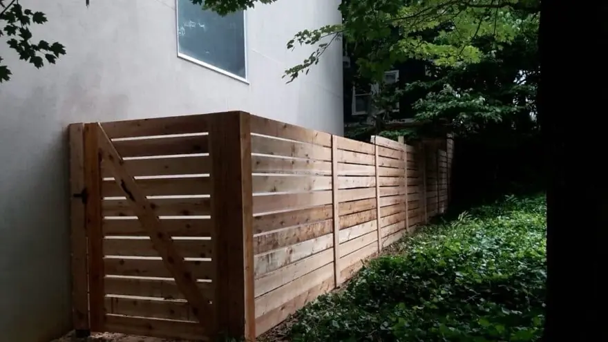 Horizontal wood semi-privacy fence with a matching gate at a residential backyard, built by FenceWorks of Georgia