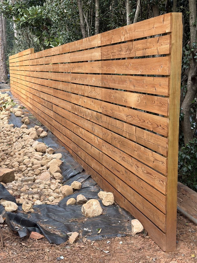 Stained horizontal wood fence in a transparent cedar tone