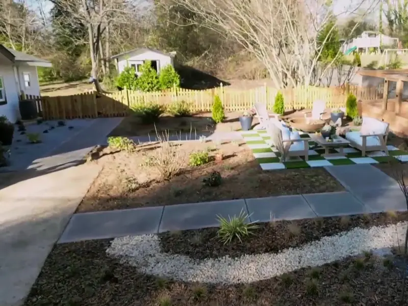 Finished scalloped cedar picket fence with French gothic posts along the renovated Atlanta backyard from HGTV's Worst Yard on the Block